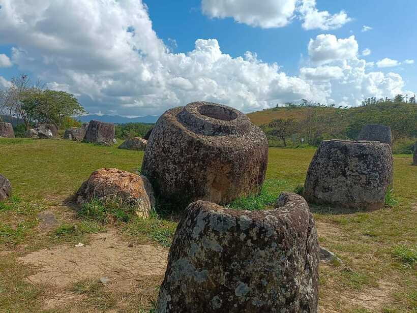 Plain of jars share group tour - Site 3 at Ban Xieng Di: the rice-field walk and wet-ground reality